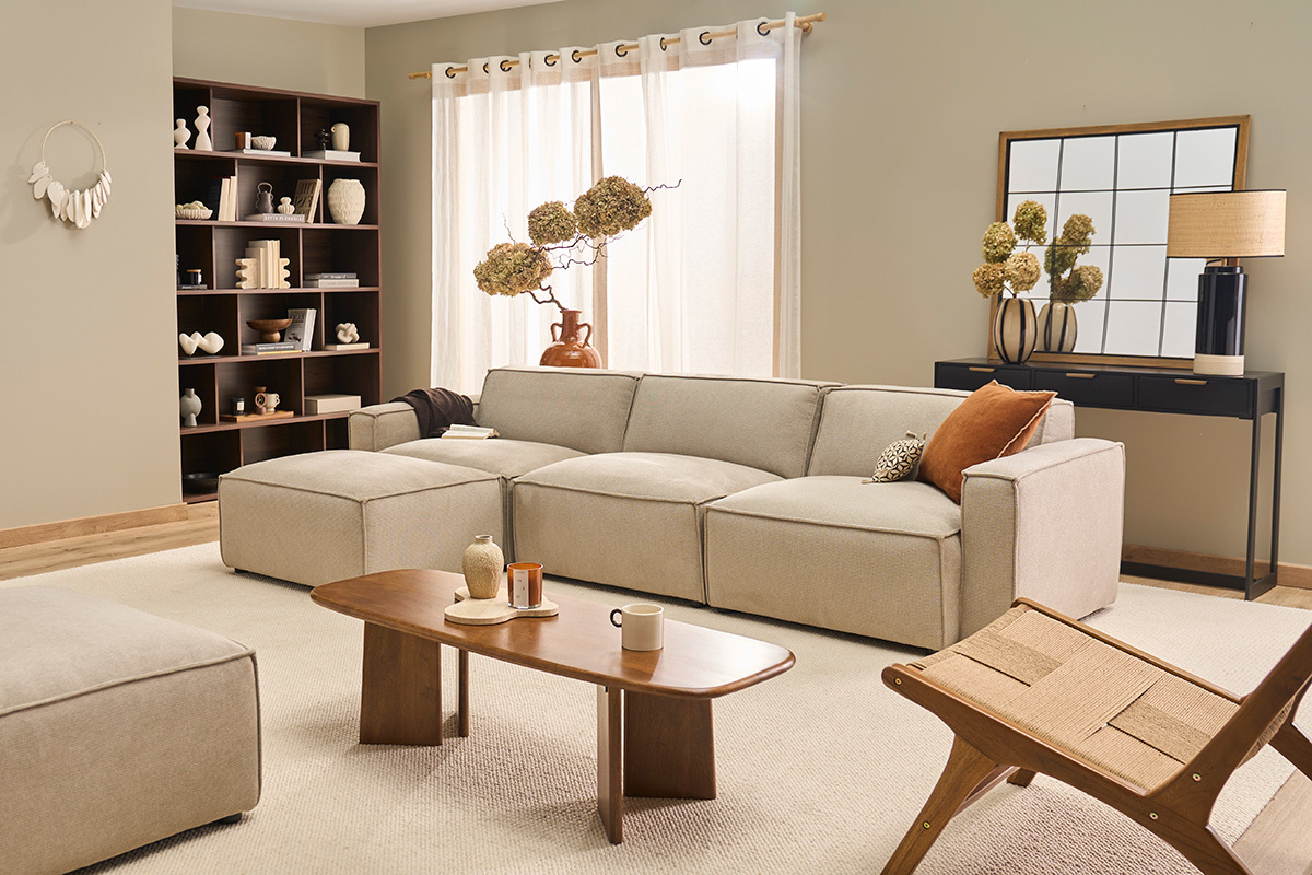 Biblioth�que EPURE en bois fonc� avec objets d�coratifs contre un mur, � c�t� d'un canap� beige.