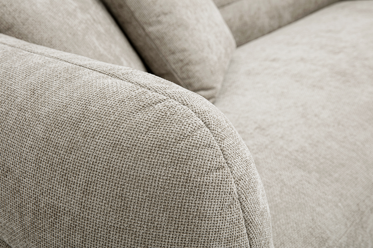 Gros plan d'un canap beige en tissu effet velours textur.