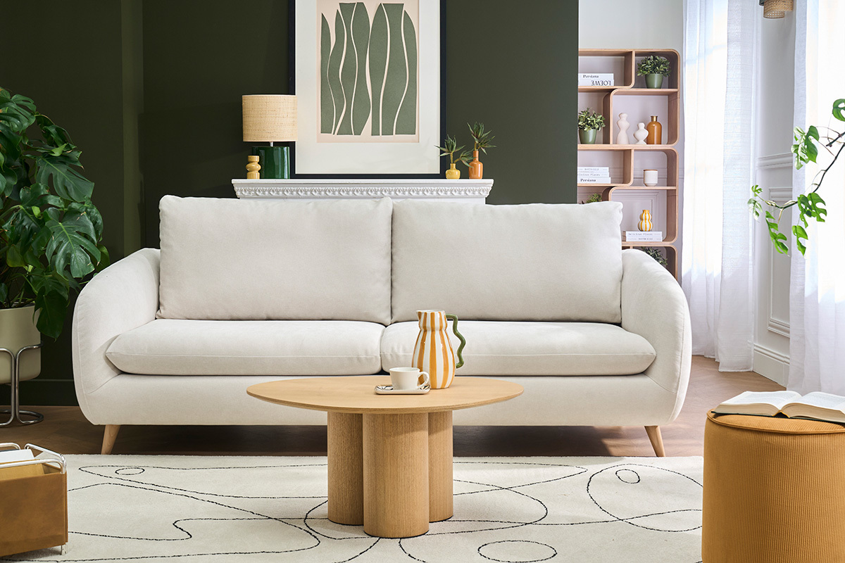 Canap� convertible 3-4 places en tissu effet velours beige avec matelas, vu de face dans un salon.