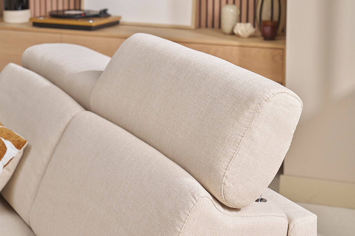 Gros plan sur les ttires ajustables d'un canap convertible en tissu beige.