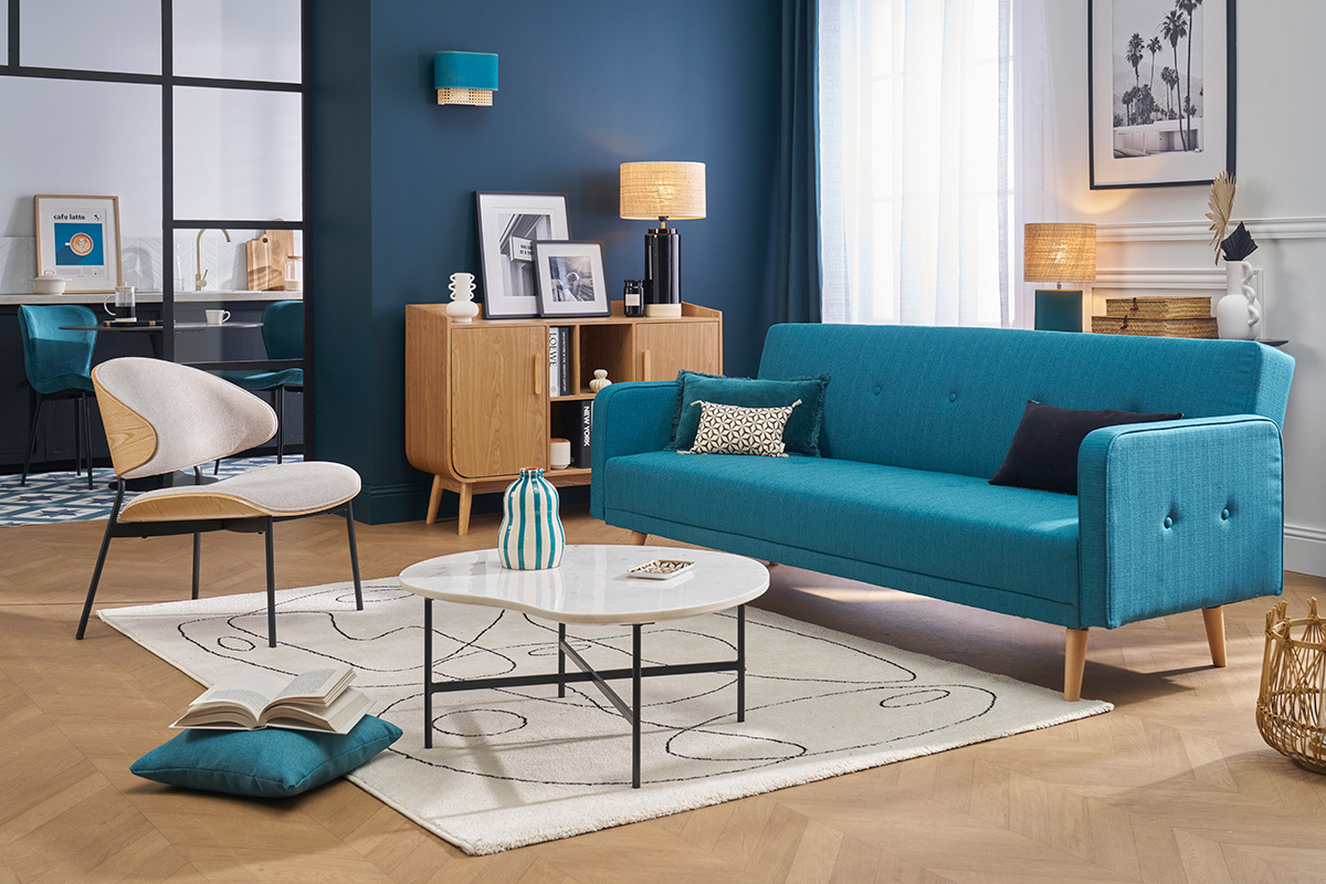 Canap convertible scandinave bleu  trois places dans un salon moderne.
