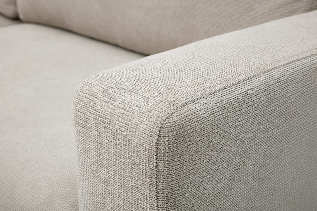 Zoom sur l'accoudoir et l'assise du canap� d'angle convertible NESTO en tissu chenille beige.