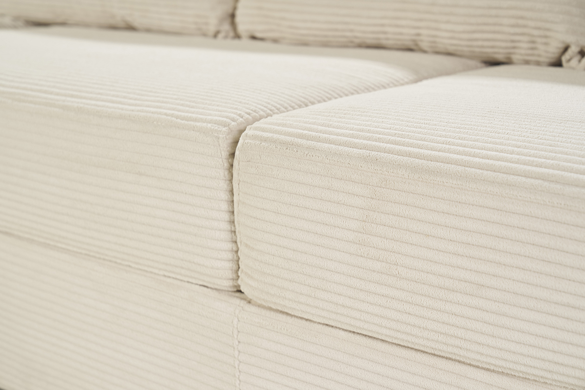 Gros plan sur le tissu velours ctel beige d'un canap.