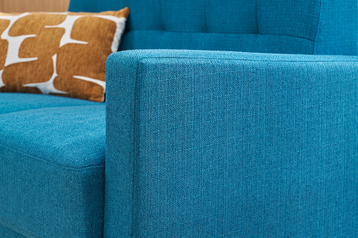 Canap scandinave bleu canard avec coussin, vue rapproche latrale.