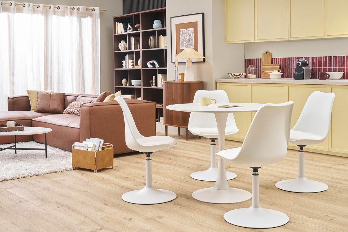 Chaises pivotantes blanches STEEVY V2 autour d'une table, dans un salon moderne.