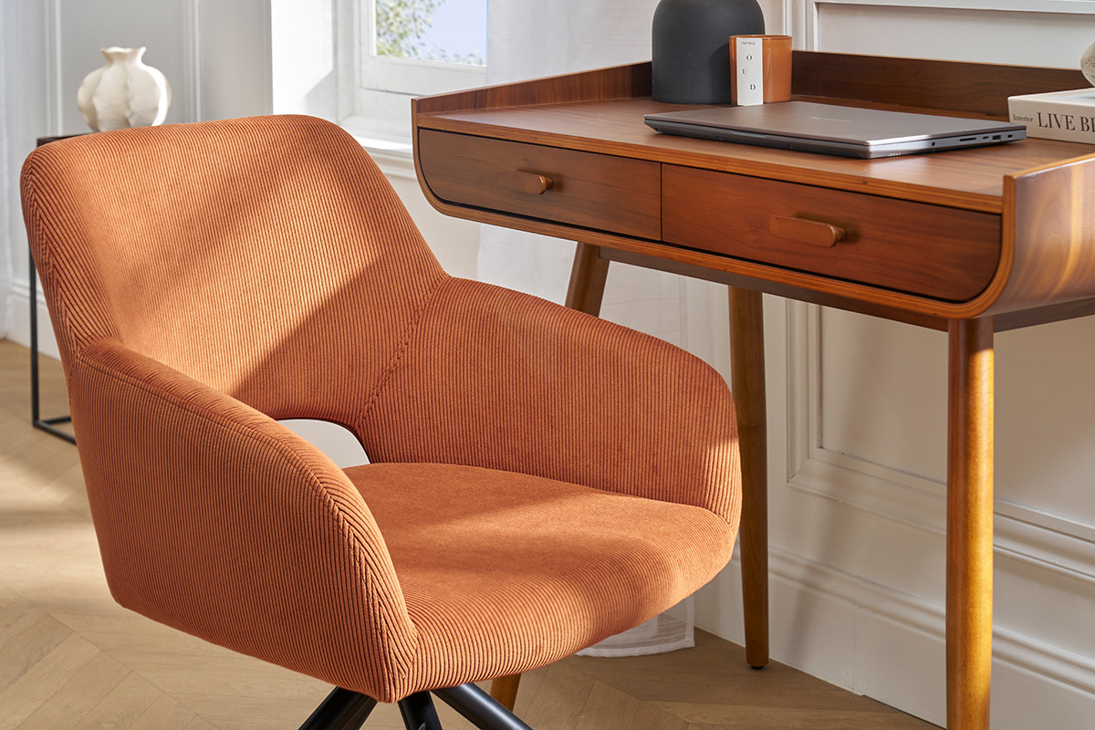 Chaise pivotante en velours ctel terre brle  ct d'un bureau en bois, vue d'intrieur.