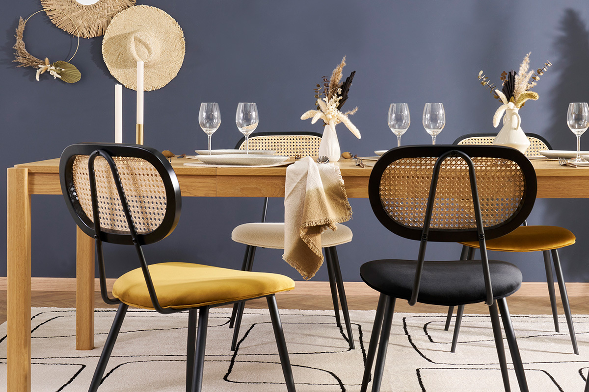 Chaises SWANN en velours noir et jaune autour d'une table en bois.