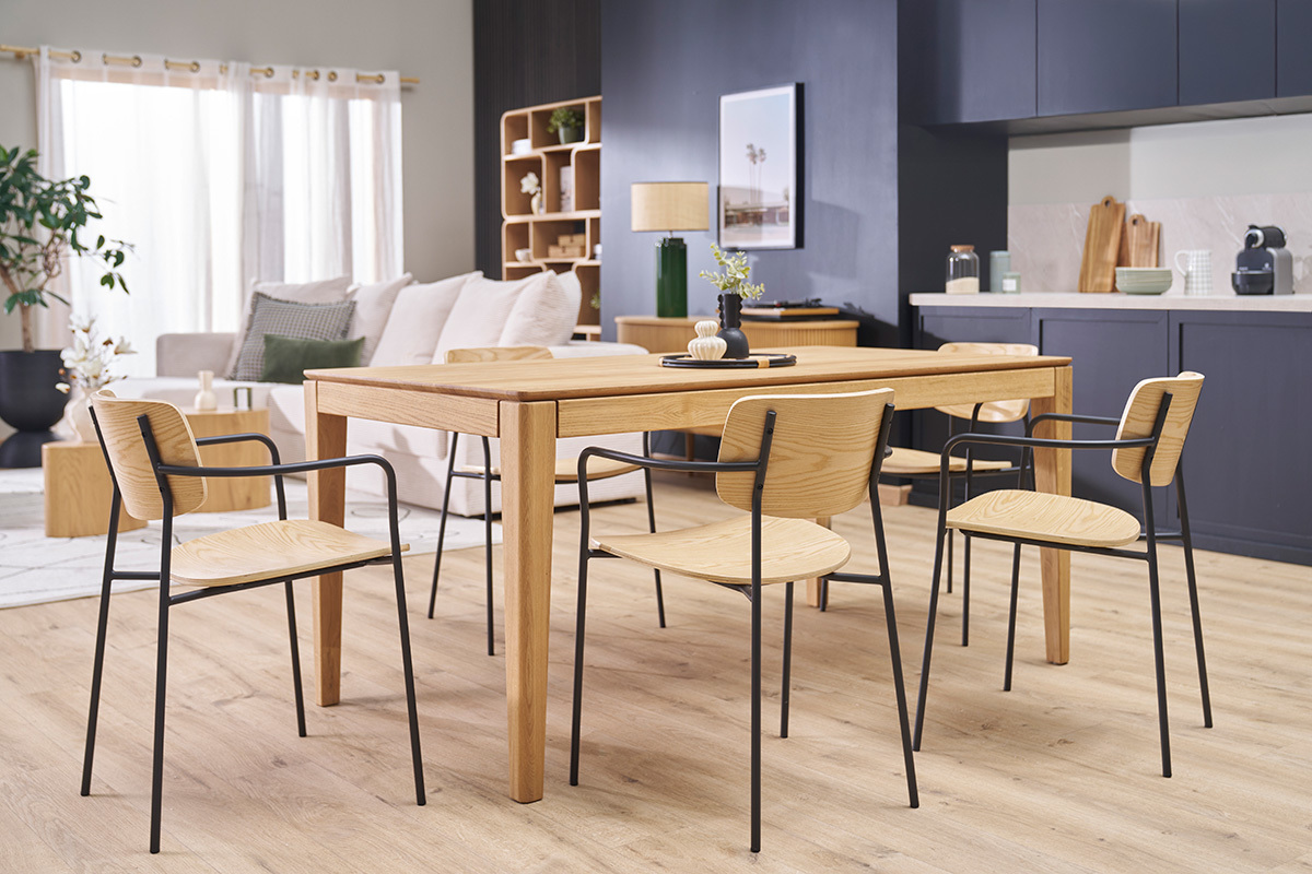 Chaises en bois clair et mtal noir autour d'une table en bois dans un intrieur moderne.