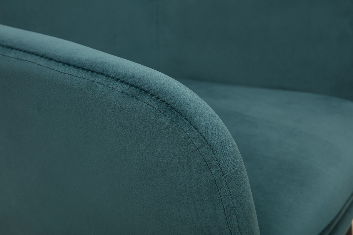 Zoom sur une chaise en velours bleu ptrole avec pitement en mtal noir, moderne et lgance