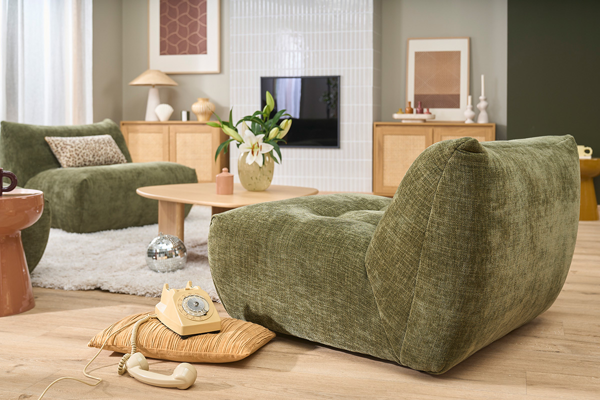 Fauteuil lounge BUMPY en tissu effet velours textur� vert kaki, vue de 3/4 dans un salon moderne.