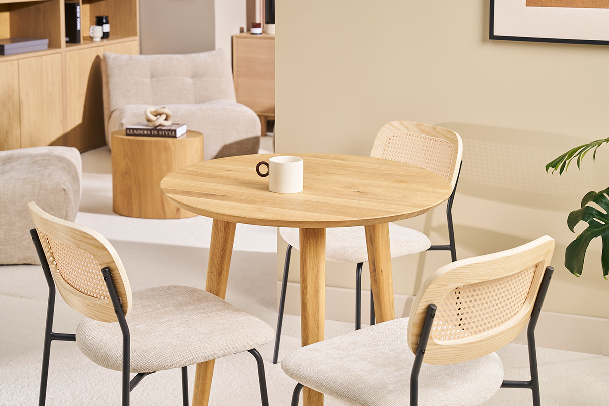 Table ronde en bois clair avec chaises, vue d'ensemble dans un int�rieur moderne.