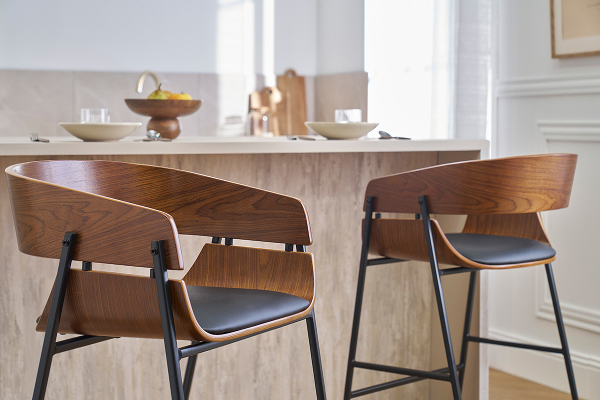 Deux tabourets de bar en bois fonc et mtal noir devant un comptoir de cuisine.