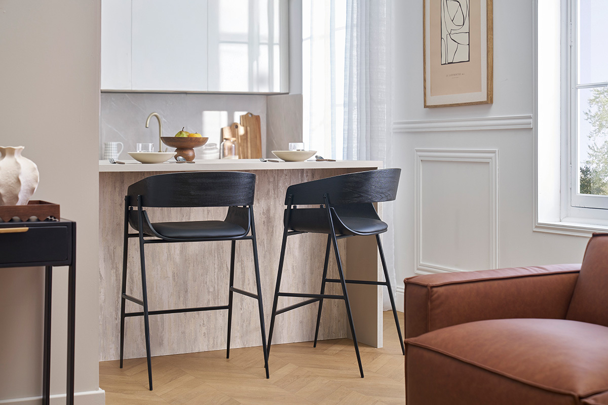 Deux tabourets de bar noirs WESS devant un lot de cuisine dans un intrieur moderne.